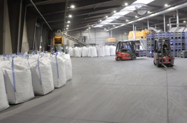 filled big bags on floor and a red truck