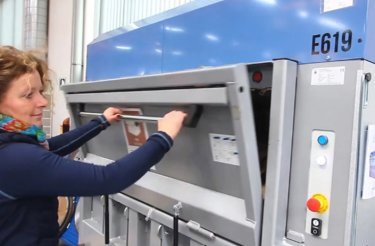 woman opening an electric baler