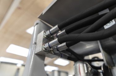 Hoses at the back of a hydraulic baler